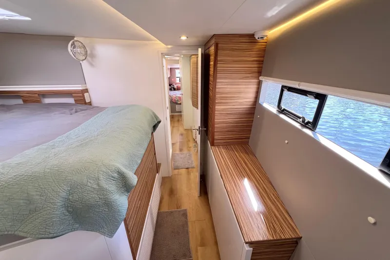 Ke'ala Yacht Photos Pics Modern interior of 2021 Balance 482 catamaran with wood accents and cozy sleeping area.