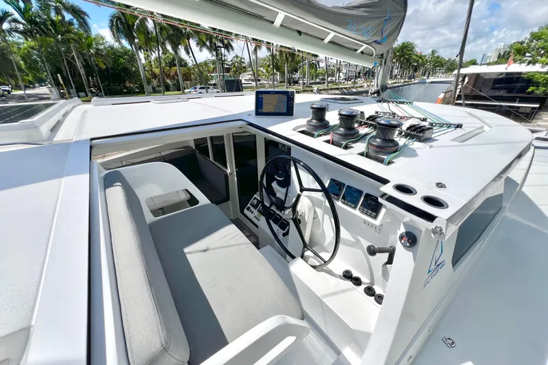 Ke'ala Yacht Photos Pics 2021 Balance 482 yacht cockpit with steering wheel, navigation controls, and winches.