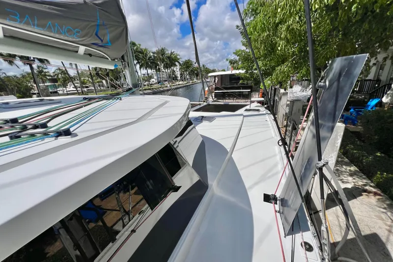 Ke'ala Yacht Photos Pics Sailing yacht Balance 482, 2021 model, docked near lush greenery and clear skies.