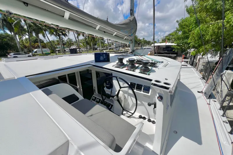 Ke'ala Yacht Photos Pics Sleek 2021 Balance 482 yacht cockpit with modern controls and lush marina backdrop.