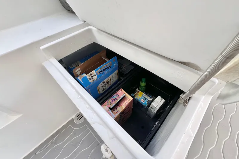 Ke'ala Yacht Photos Pics Storage compartment on a 2021 Balance 482 boat, containing various boxed items.