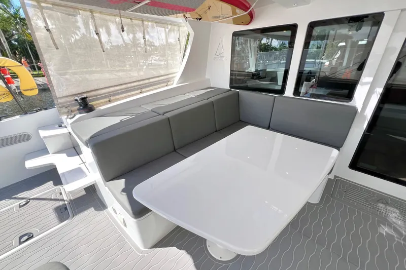 Ke'ala Yacht Photos Pics Modern Balance 482 yacht interior with sleek seating and table, 2021 model.