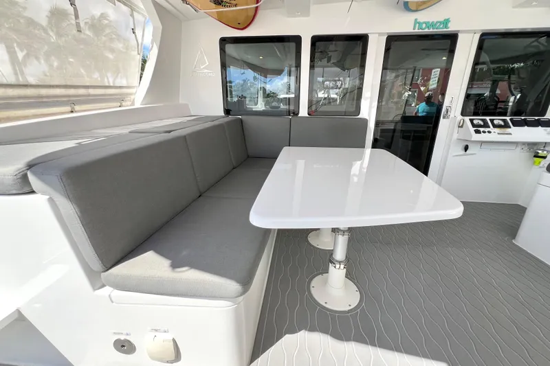 Ke'ala Yacht Photos Pics Modern Balance 482 yacht interior with gray seating and sleek white table, 2021 model.