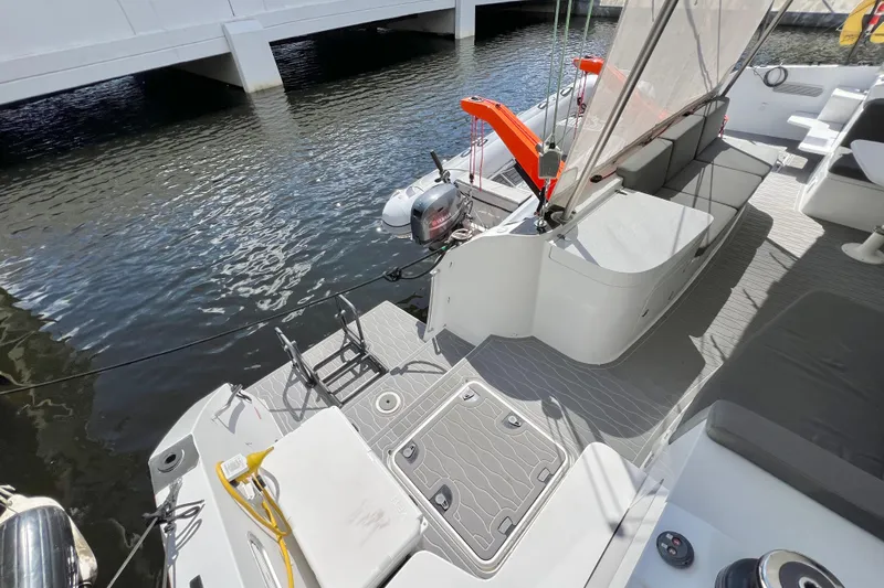 Ke'ala Yacht Photos Pics Modern Balance 482 yacht deck with seating, motor, and water view, 2021 model.