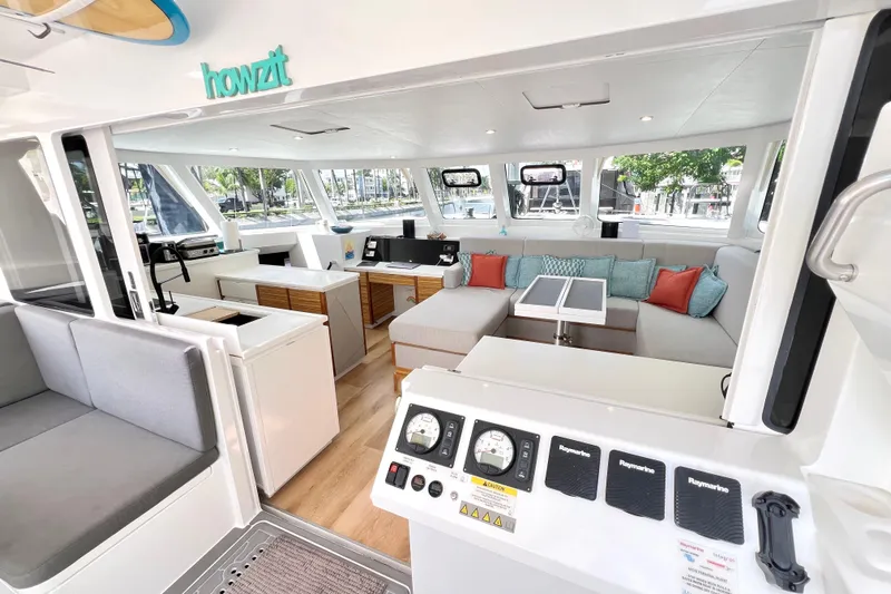 Ke'ala Yacht Photos Pics Luxurious interior of 2021 Balance 482 catamaran with modern seating and navigation controls.