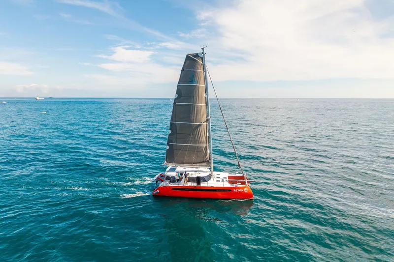 Ke'ala Yacht Photos Pics Red Balance 482 catamaran sailing on open sea, 2021 model.