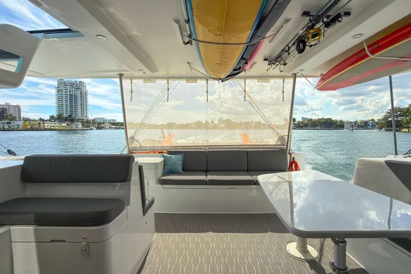 Ke'ala Yacht Photos Pics Interior view of 2021 Balance 482 yacht with seating, table, and water view.