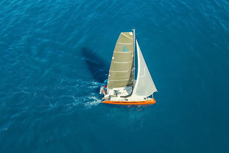 Ke'ala Yacht Photos Pics Aerial view of 2021 Balance 482 sailboat navigating clear blue ocean waters.