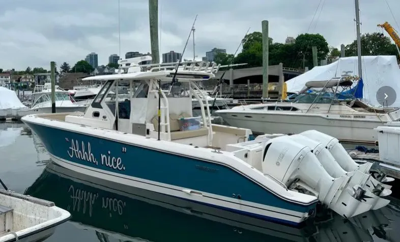 "ahhh Nice" Yacht Photos Pics 2018 Pursuit S 368 Sport boat docked, blue and white design.