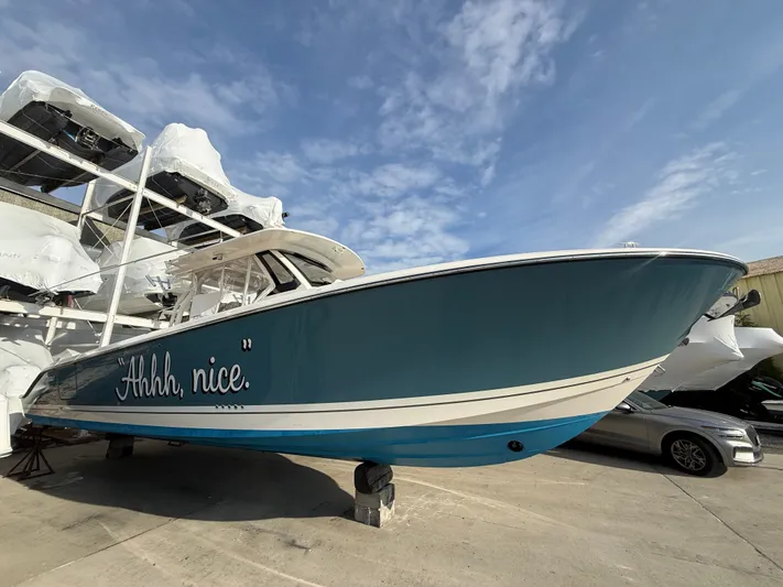 "ahhh Nice" Yacht Photos Pics 2018 Pursuit S 368 Sport boat with blue hull in marina.