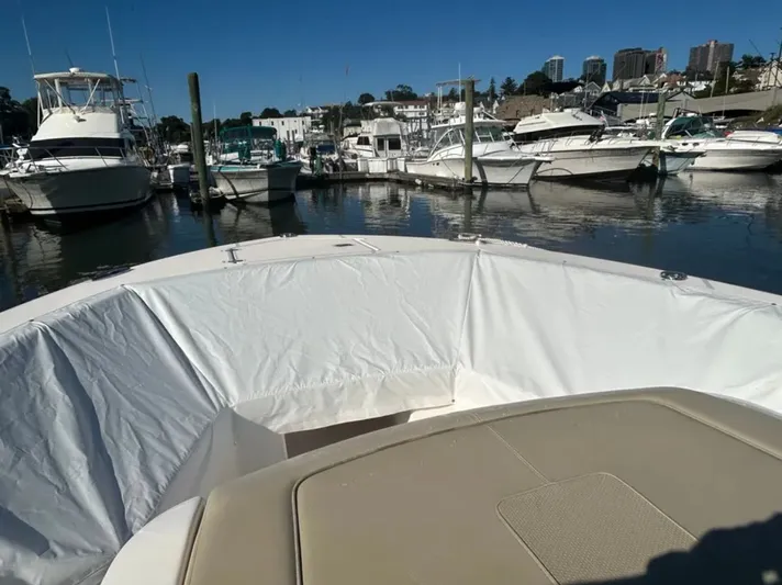 "ahhh Nice" Yacht Photos Pics 2018 Pursuit S 368 Sport in a marina with other boats.