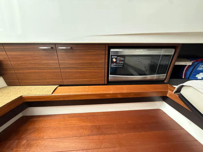 "ahhh Nice" Yacht Photos Pics Interior of 2018 Pursuit S 368 Sport with microwave and wood paneling.