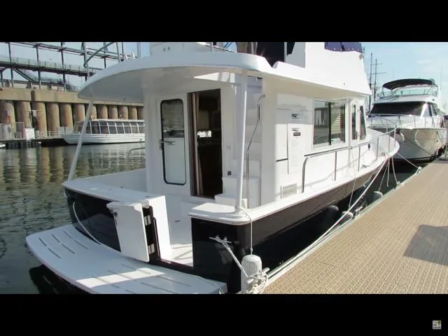 Mano 1 Yacht Photos Pics 2011 Mainship 395 Trawler docked at marina, showcasing sleek design and spacious deck.