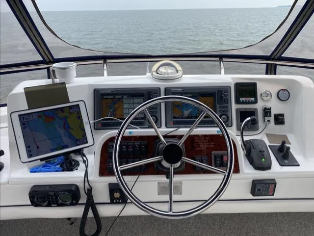 Mano 1 Yacht Photos Pics 2011 Mainship 395 Trawler helm with navigation equipment and ocean view.