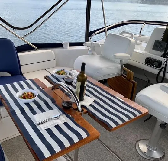 Mano 1 Yacht Photos Pics Luxurious dining setup on 2011 Mainship 395 Trawler with wine and appetizers.