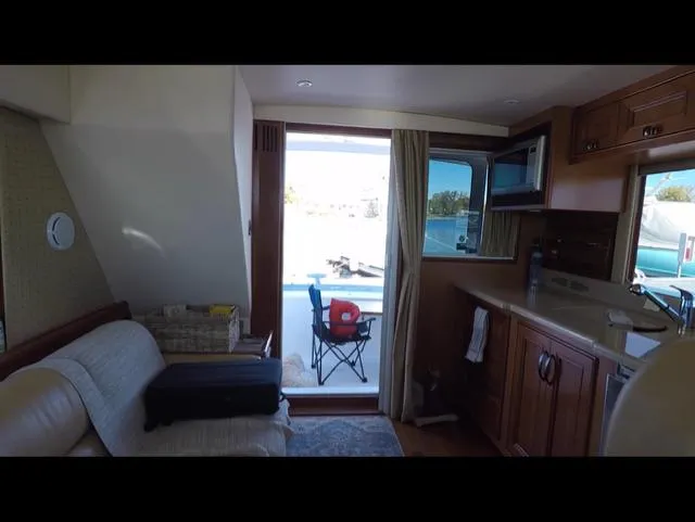 Mano 1 Yacht Photos Pics Interior of 2011 Mainship 395 Trawler with cozy seating and kitchenette.