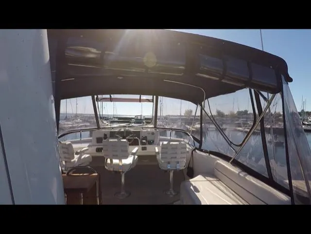 Mano 1 Yacht Photos Pics 2011 Mainship 395 Trawler interior with helm, seating, and marina view.