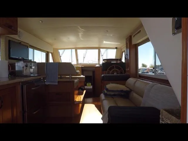 Mano 1 Yacht Photos Pics Interior of 2011 Mainship 395 Trawler with cozy seating and helm station.