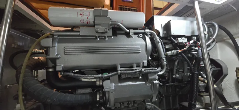 Mano 1 Yacht Photos Pics Engine room of 2011 Mainship 395 Trawler, showcasing detailed mechanical components.