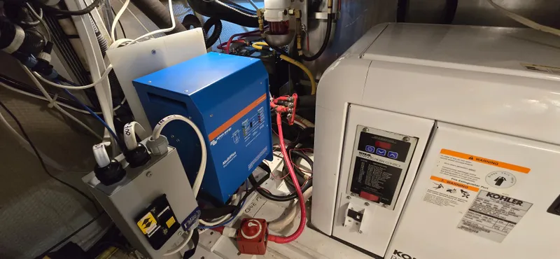 Mano 1 Yacht Photos Pics Engine room of 2011 Mainship 395 Trawler with electrical equipment and wiring.