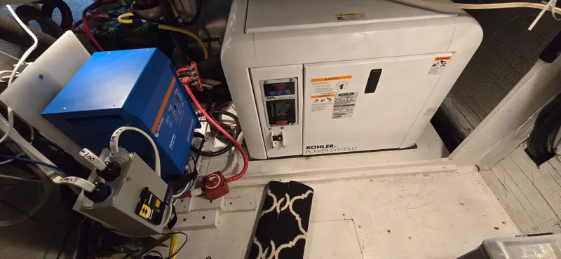 Mano 1 Yacht Photos Pics Engine room of 2011 Mainship 395 Trawler with generator and electrical components.