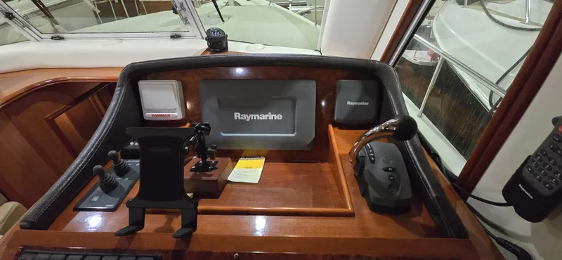 Mano 1 Yacht Photos Pics 2011 Mainship 395 Trawler helm with Raymarine navigation system and control panel.