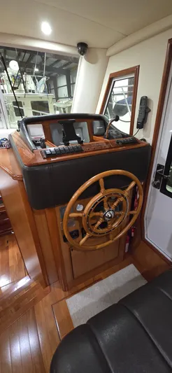 Mano 1 Yacht Photos Pics 2011 Mainship 395 Trawler helm with wooden wheel and navigation instruments.