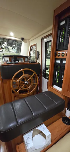 Mano 1 Yacht Photos Pics 2011 Mainship 395 Trawler helm with wooden wheel and control panels.