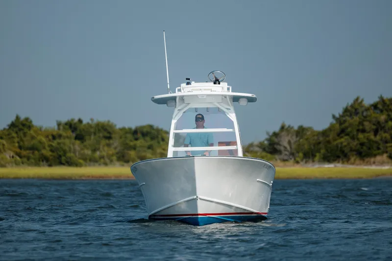  Yacht Photos Pics 2019 Gamefisherman 26 Cuddy Cabin boat cruising on open water.