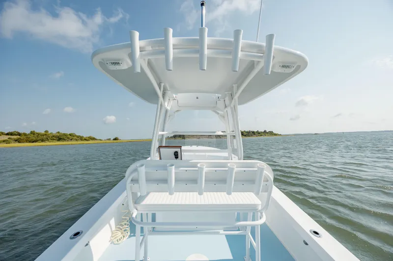  Yacht Photos Pics 2019 Gamefisherman 26 Cuddy Cabin boat on calm water, clear sky background.