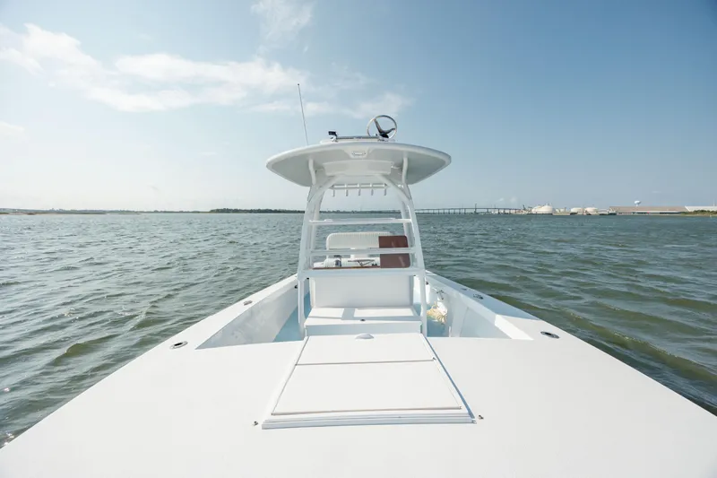  Yacht Photos Pics 2019 Gamefisherman 26 Cuddy Cabin boat on open water under clear blue sky.