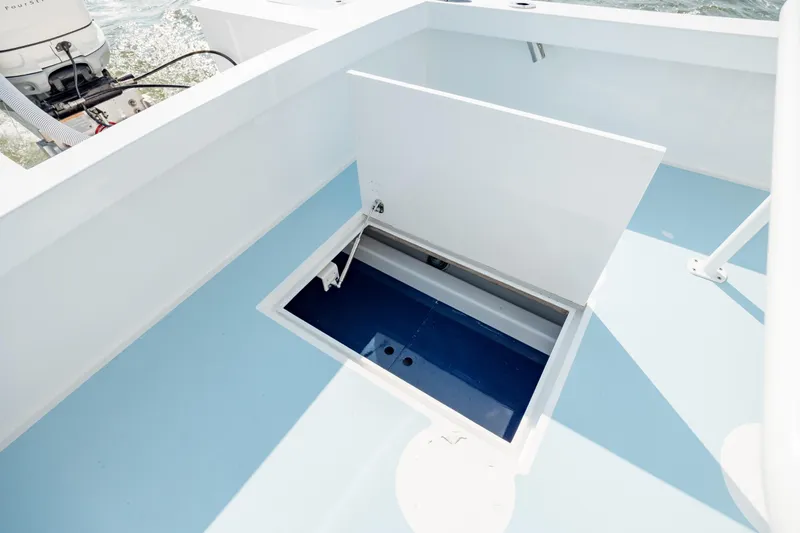  Yacht Photos Pics Open storage compartment on 2019 Gamefisherman 26 Cuddy Cabin boat deck.