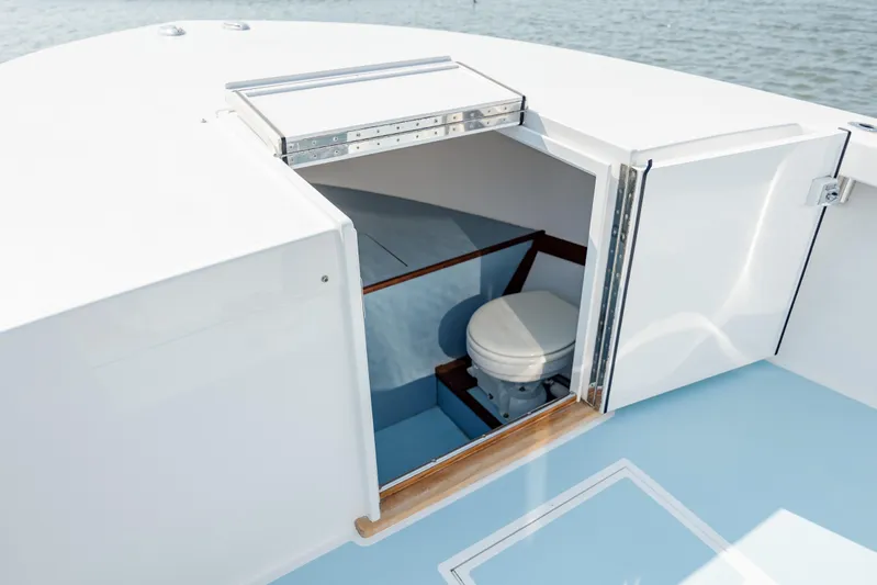  Yacht Photos Pics 2019 Gamefisherman 26 Cuddy Cabin boat with open hatch revealing interior toilet.