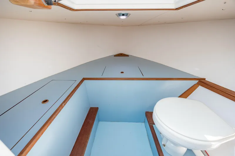  Yacht Photos Pics 2019 Gamefisherman 26 Cuddy Cabin interior with toilet and storage compartments.