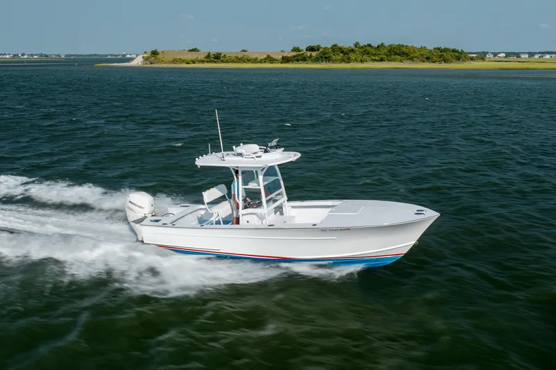  Yacht Photos Pics 2019 Gamefisherman 26 Cuddy Cabin cruising on open water, showcasing sleek design and performance.