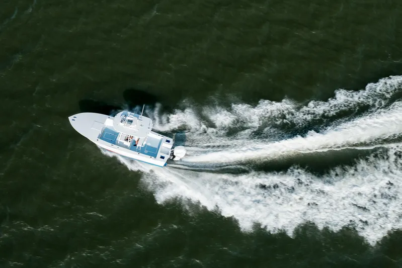  Yacht Photos Pics Aerial view of 2019 Gamefisherman 26 Cuddy Cabin cruising on open water.