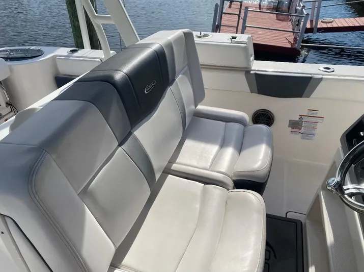  Yacht Photos Pics 2021 Robalo R272 Center Console boat seating area by the dock.