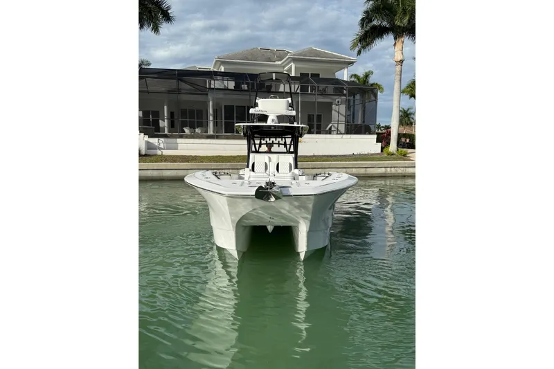  Yacht Photos Pics 2020 SeaHunter 41 CTS boat docked in front of a modern waterfront home.