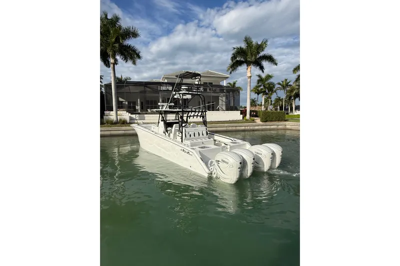  Yacht Photos Pics 2020 SeaHunter 41 CTS boat with triple Yamaha engines docked near palm trees.