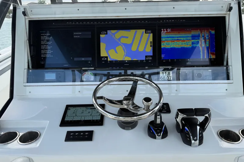  Yacht Photos Pics Control panel of 2020 SeaHunter 41 CTS boat with navigation screens and steering wheel.
