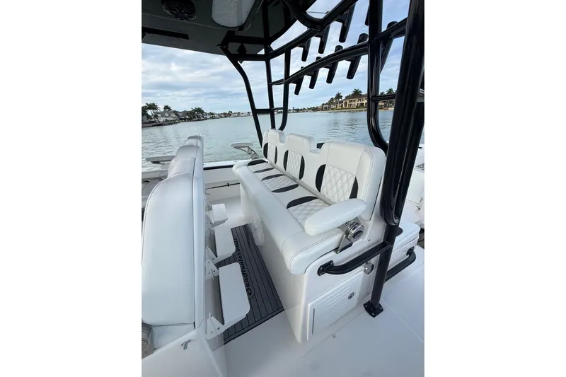  Yacht Photos Pics 2020 SeaHunter 41 CTS boat interior with white seating and rod holders, overlooking calm waters.