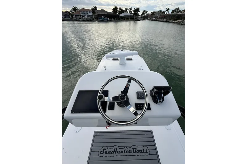  Yacht Photos Pics 2020 SeaHunter 41 CTS boat helm with steering wheel and controls on calm water.