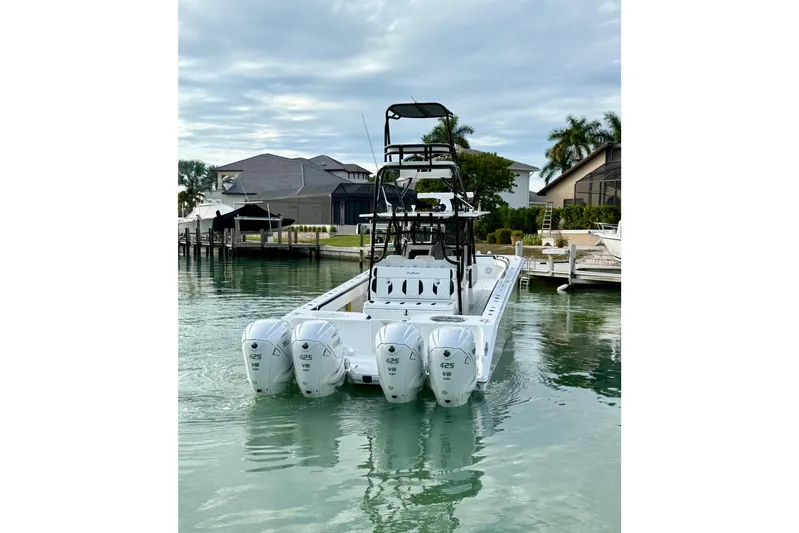  Yacht Photos Pics 2020 SeaHunter 41 CTS boat with four powerful engines docked in a serene marina.