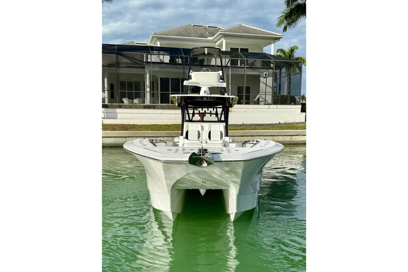  Yacht Photos Pics 2020 SeaHunter 41 CTS boat docked in front of a modern waterfront home.