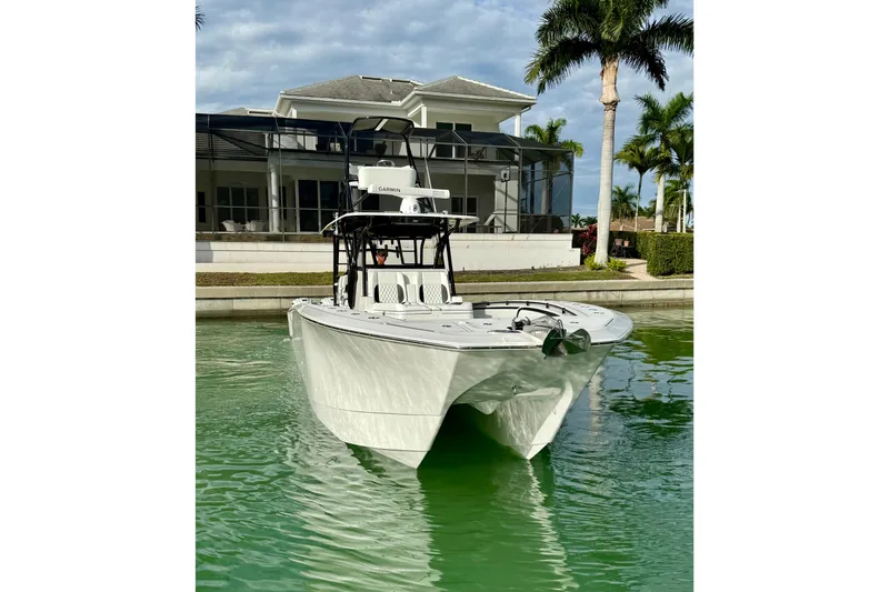  Yacht Photos Pics 2020 SeaHunter 41 CTS boat docked near a waterfront home with palm trees.