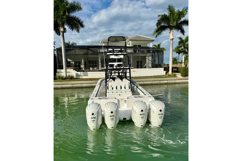  Yacht Photos Pics 2020 SeaHunter 41 CTS boat with four powerful engines docked near a modern house.