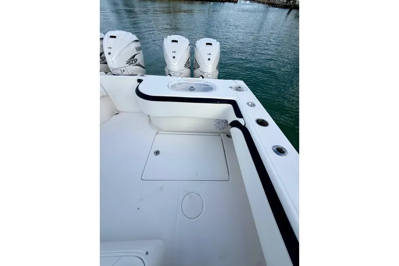  Yacht Photos Pics 2020 SeaHunter 41 CTS boat deck with triple outboard engines on water.