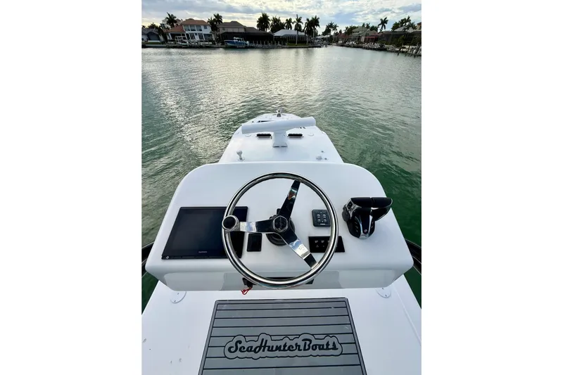  Yacht Photos Pics 2020 SeaHunter 41 CTS boat helm with steering wheel and controls on calm water.