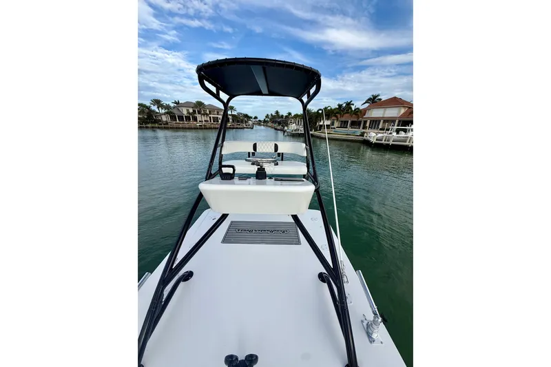  Yacht Photos Pics 2020 SeaHunter 41 CTS boat on a calm waterway, surrounded by waterfront homes.