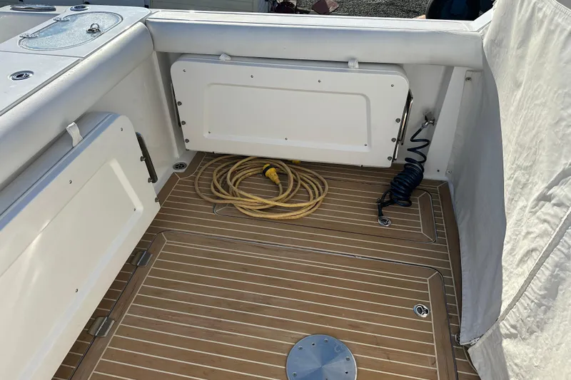  Yacht Photos Pics 2020 Southport 33DC boat deck with coiled hose and wooden flooring.